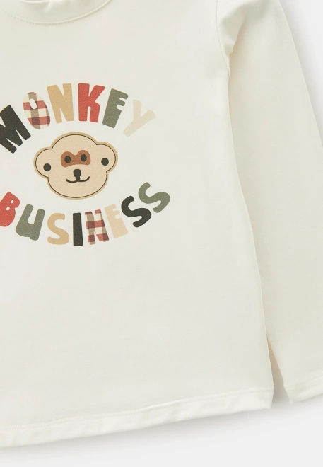 Лонгслив молочного цвета с ярким рисунком 